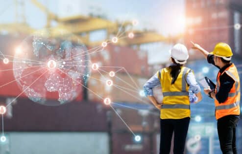 Teamwork of workers using tablet to monitor supply chain with GPS tracking on cellular IoT network distribution and smart transportation on networking of container cargo IIoT