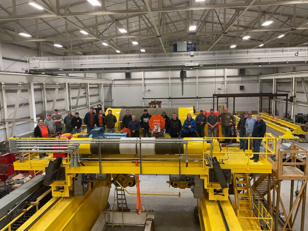 Construction workers on site with crane in the background