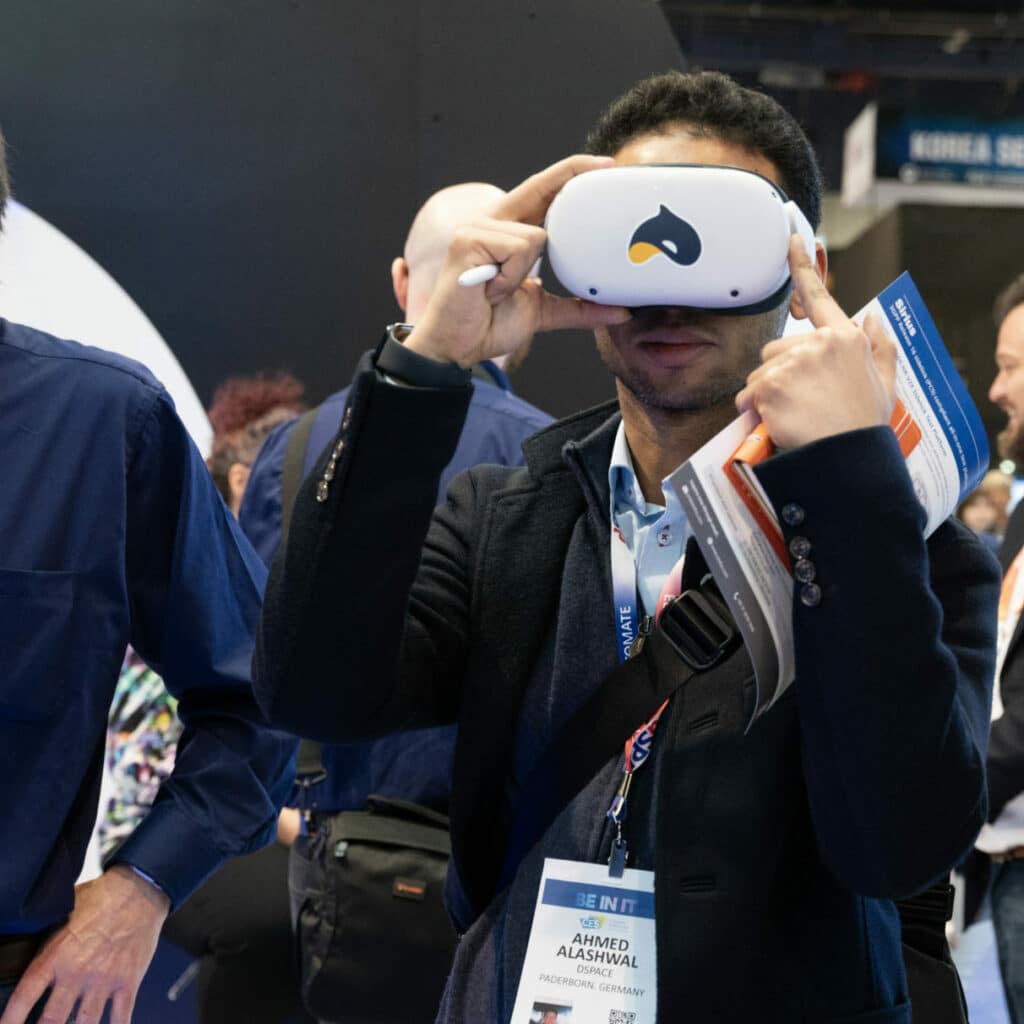 Blues booth visitor interacting with a Prodigy IoT product that connects with the Metaverse